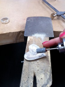 Grinding away the sprue edges.