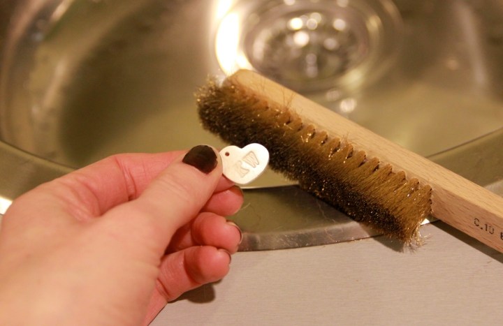 Brushing away the white coating to reveal silver!